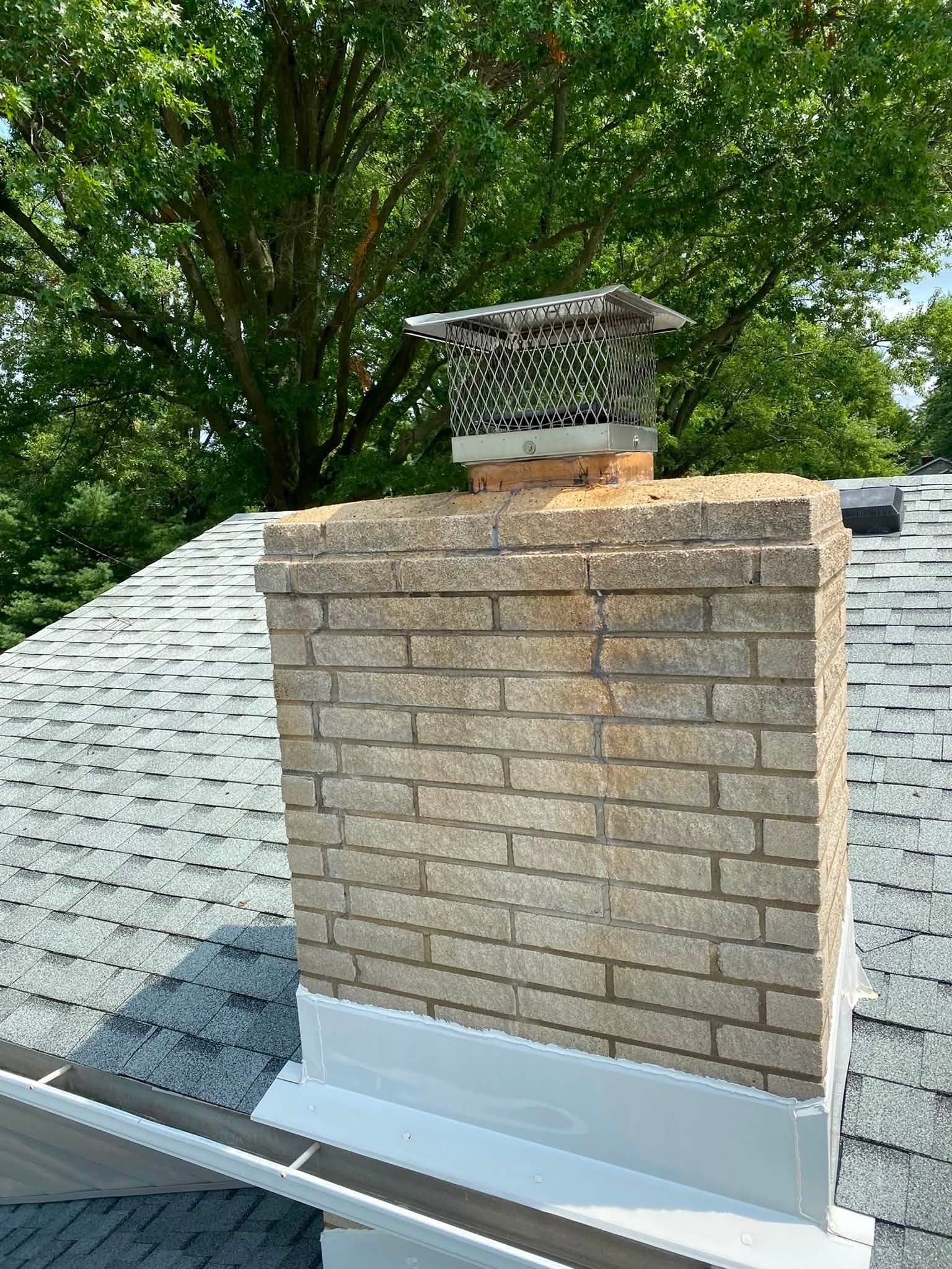The same chimney after a soft wash, the brick back to a clean sand color