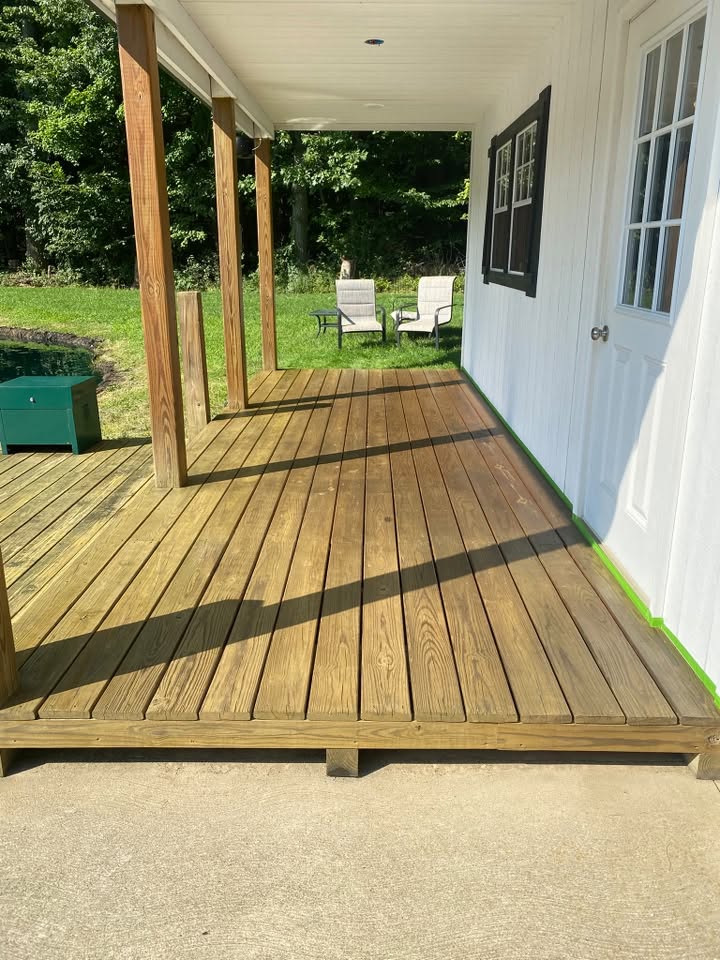 The same deck cleaned back to warm bare wood grain