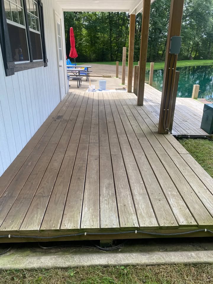 Wooden deck boards gone green and gray with algae before cleaning